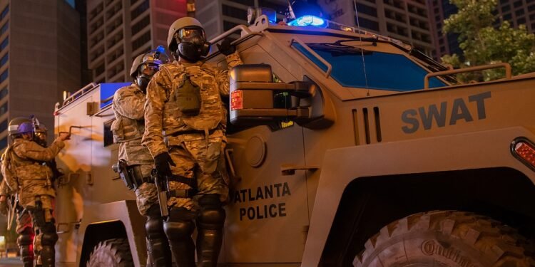 U.S. Airmen with the Georgia Air National Guard’s 116th Security Forces Squadron (SFS) and 165th SFS assist City of Atlanta SWAT team members conducting area presence patrols while enforcing a curfew during ongoing civil unrest near Centennial Olympic Park in Atlanta, Georgia, June 4, 2020. Georgia National Guardsmen are assisting law enforcement agencies to protect property, prevent destruction of infrastructure, and ensure the safety of Georgia citizens. (U.S. Air National Guard photo by Senior Master Sgt. Roger Parsons)